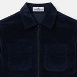 A close-up of a dark navy blue corduroy zip-up jacket by Stone Island, featuring a collar, a front zipper, and two chest pockets, set against a light gray background.