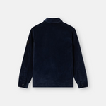 A dark navy blue long-sleeve jacket shown from the back, featuring a subtle textured fabric and a small black brand patch on the left sleeve, set against a plain light gray background.