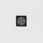 A small black square patch with the circular Stone Island compass logo in white, centered on a light gray background.