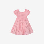 Pink dress with small floral pattern on a white background