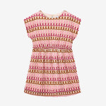 Pink and brown patterned dress on a light gray background