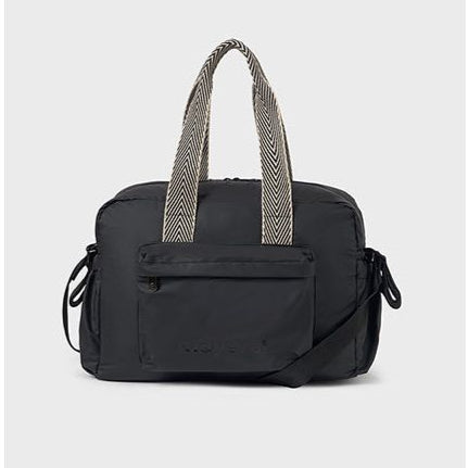 A black changing bag with a front pocket and textured strap details.