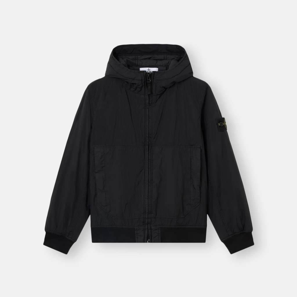 A black hooded zip-up jacket with a drawstring hood, ribbed cuffs and hem, and a small black badge on the left sleeve, displayed against a light gray background.