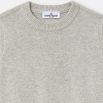 Close-up of a light gray knit crewneck sweater with a visible Stone Island neck label.