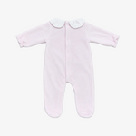 A light pink baby footed sleeper with long sleeves, a white ruffled Peter Pan collar, and an all-on-the-back zipper, laid flat on a neutral gray background.