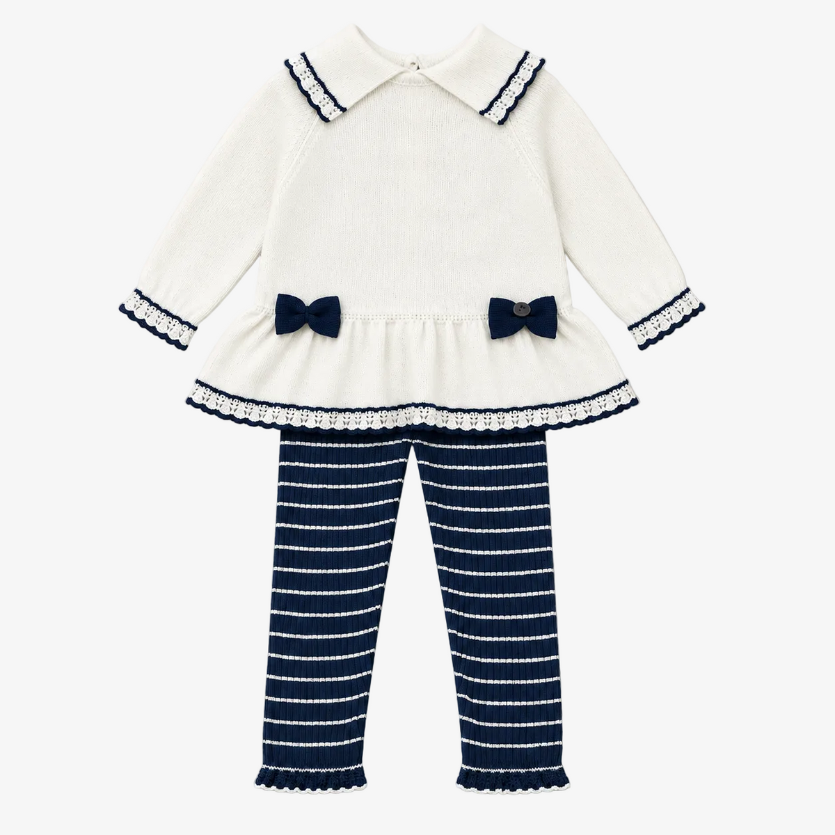 A toddler girl's two-piece knit outfit set featuring a cream long-sleeve top with navy blue trim, bow details, and a ruffled hem, paired with navy blue and cream horizontally striped pants, laid flat on a light beige background.