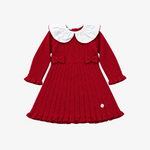 A red ribbed knit long-sleeve dress for toddlers, featuring a large white Peter Pan collar, matching red bows on the chest, and a pleated skirt, shown flat on a light gray background.