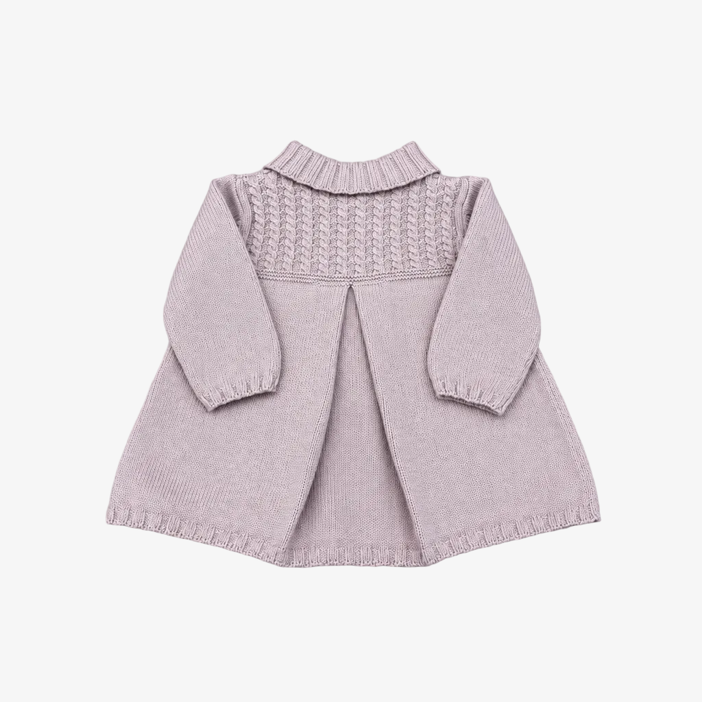 A light pink knitted baby cardigan with long sleeves, a textured cable-knit yoke, and a ruffled mock neck, laid flat on a neutral gray background.