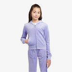 Person wearing a lavender tracksuit with a brand logo on a light gray background