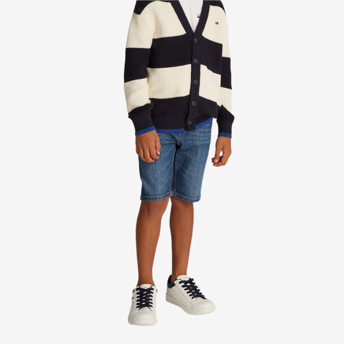 A child model wearing slim-fit blue denim shorts with five pockets and whiskered detailing on the front.