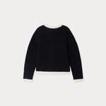 Black sweater with white trim on a light gray background