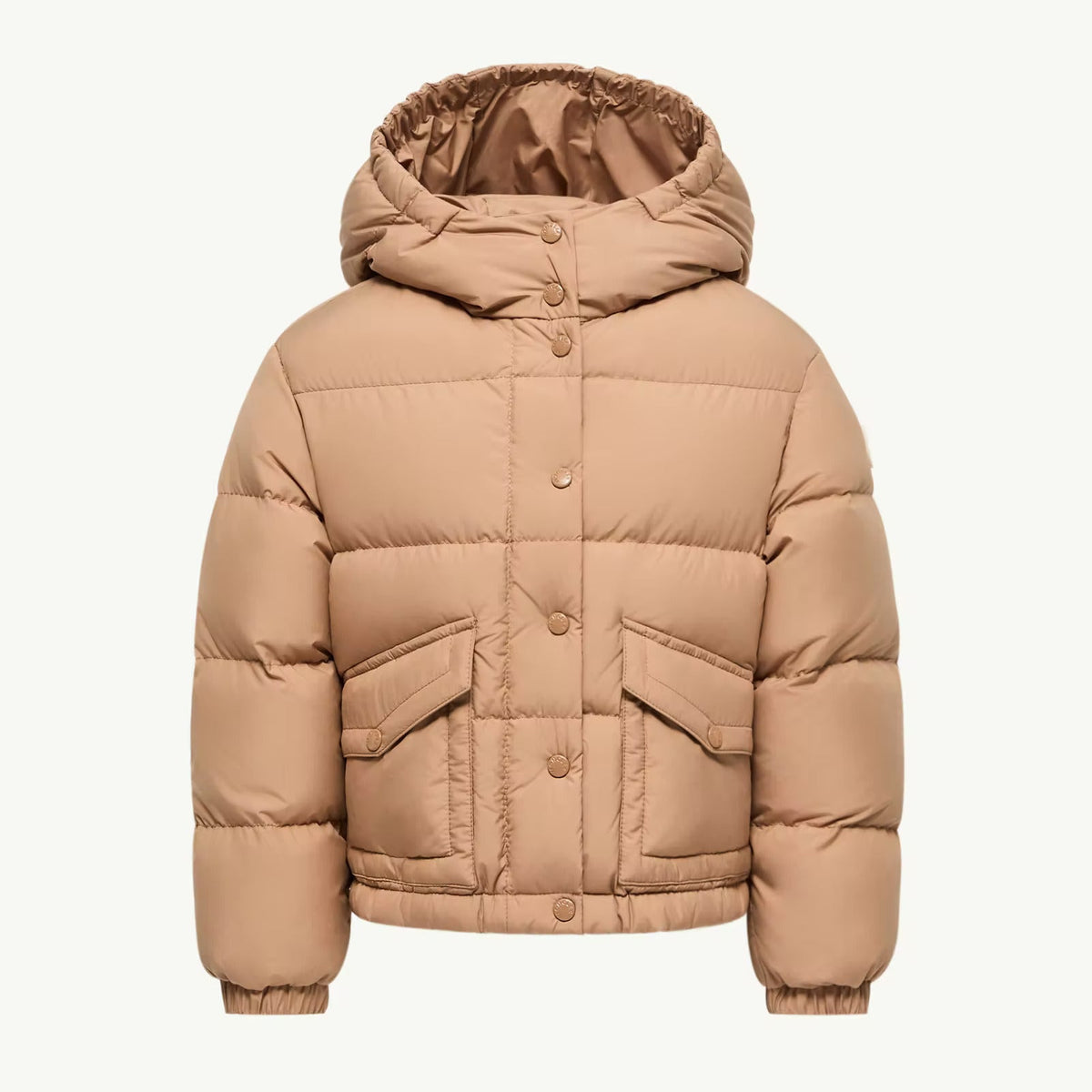 A light tan hooded puffer jacket with horizontal quilting, snap-button front, and two front flap pockets, shown on a plain off-white background.