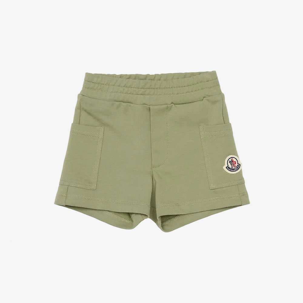 Green shorts with a brand logo on a white background