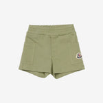 Green shorts with a brand logo on a white background
