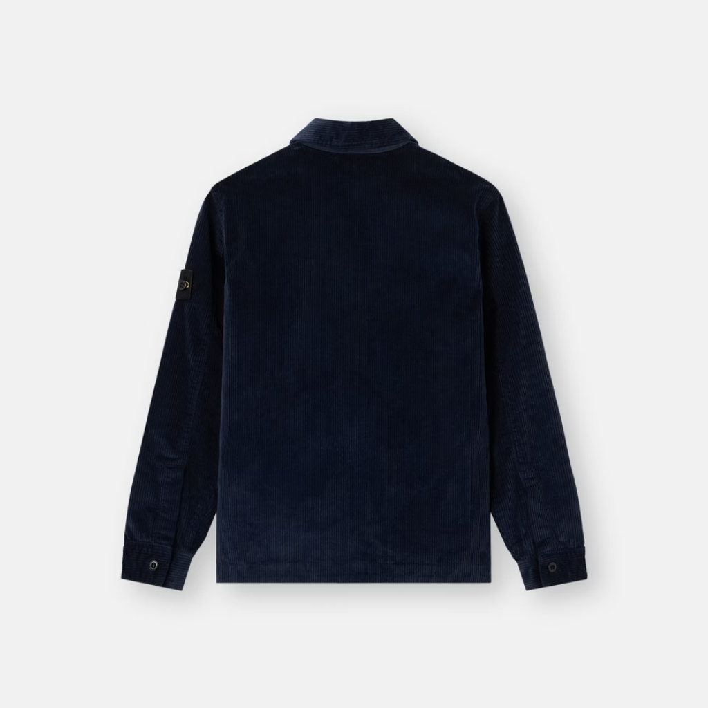 A dark navy blue long-sleeve jacket shown from the back, featuring a subtle textured fabric and a small black brand patch on the left sleeve, set against a plain light gray background.