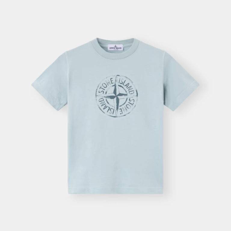A light blue short-sleeve crewneck t-shirt with a dark blue circular compass logo printed on the chest.