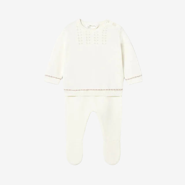 White baby outfit with long-sleeve top and footed pants on a light gray background