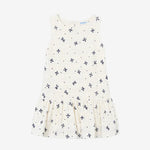 White sleeveless dress with small black floral pattern on a white background