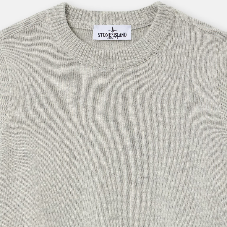 Close-up of a light gray knit crewneck sweater with a visible Stone Island neck label.