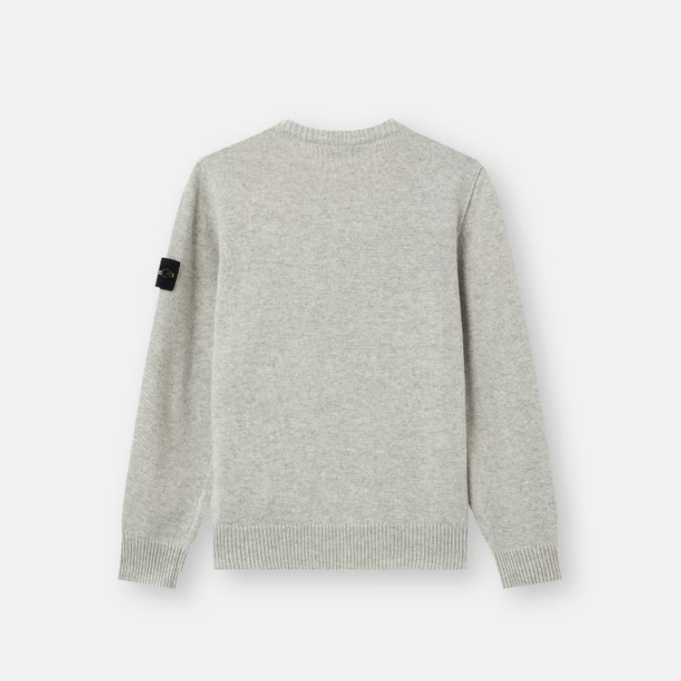 A light gray heather knit sweater shown from the back, featuring a small black rectangular brand patch on the left sleeve.