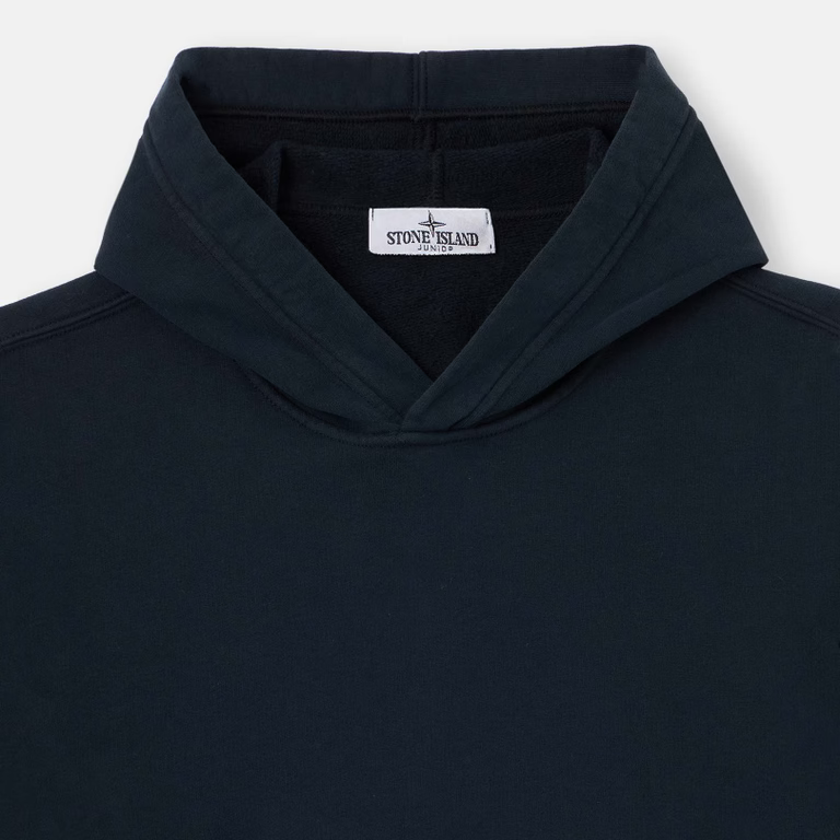 Close-up of a dark navy hooded sweatshirt with a visible Stone Island neck label.
