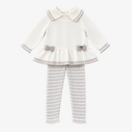 A toddler girl's two-piece knit outfit set featuring a cream long-sleeve top with lace trim and gray bows, paired with gray and white striped leggings with lace cuffs, displayed on a solid light beige background.