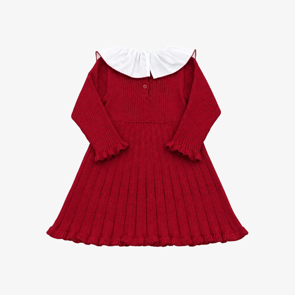 A red ribbed knit long-sleeve dress for toddlers, featuring a contrasting white ruffled Peter Pan collar and a pleated skirt, laid flat on a light gray background.
