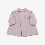 A dusty pink knit baby cardigan with a ruffled collar, button front, and textured chest panel, laid flat on a neutral gray background.