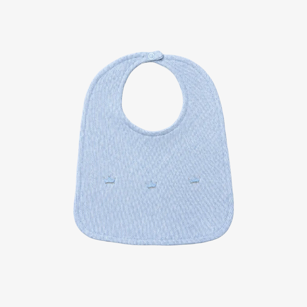 A light blue textured fabric baby bib with a small snap button at the top, shown on a neutral light gray background.