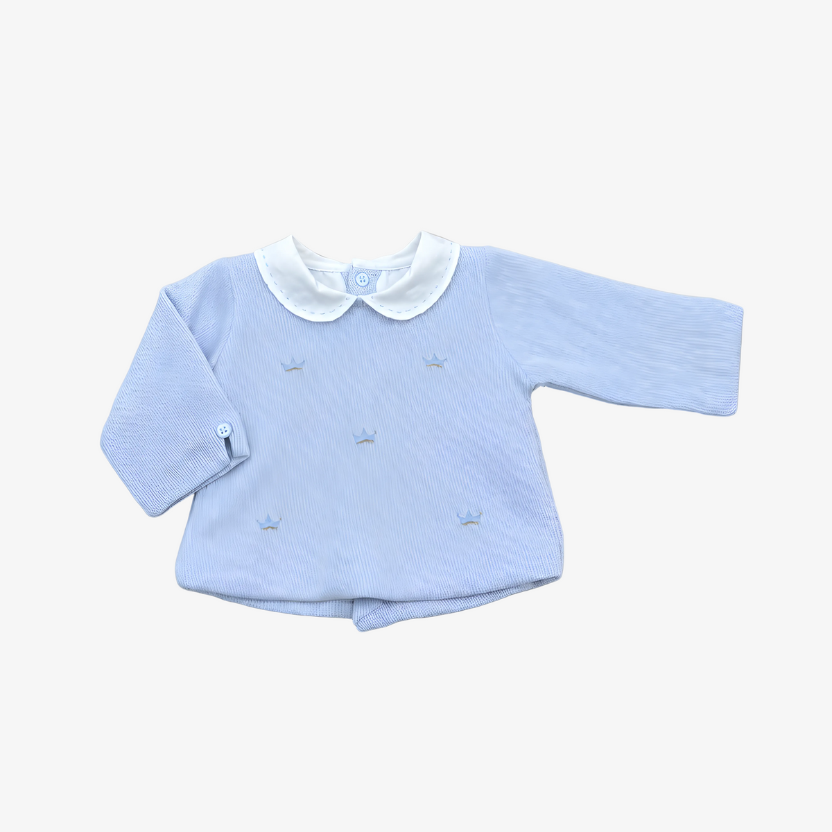 A light blue long-sleeve baby top with a white Peter Pan collar and small embroidered crowns, laid flat on a neutral gray background.