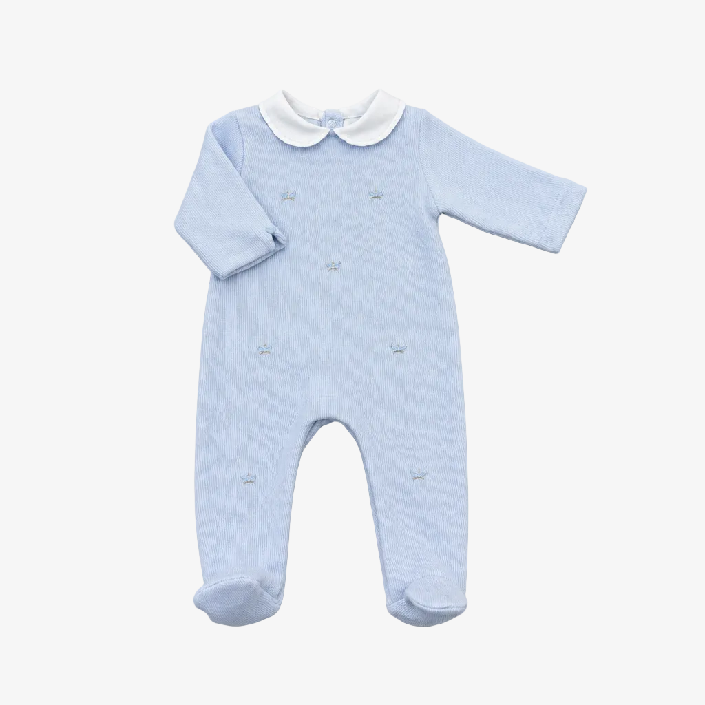 A light blue long-sleeve baby footed romper with a white Peter Pan collar and small embroidered details, laid flat on a neutral gray background.