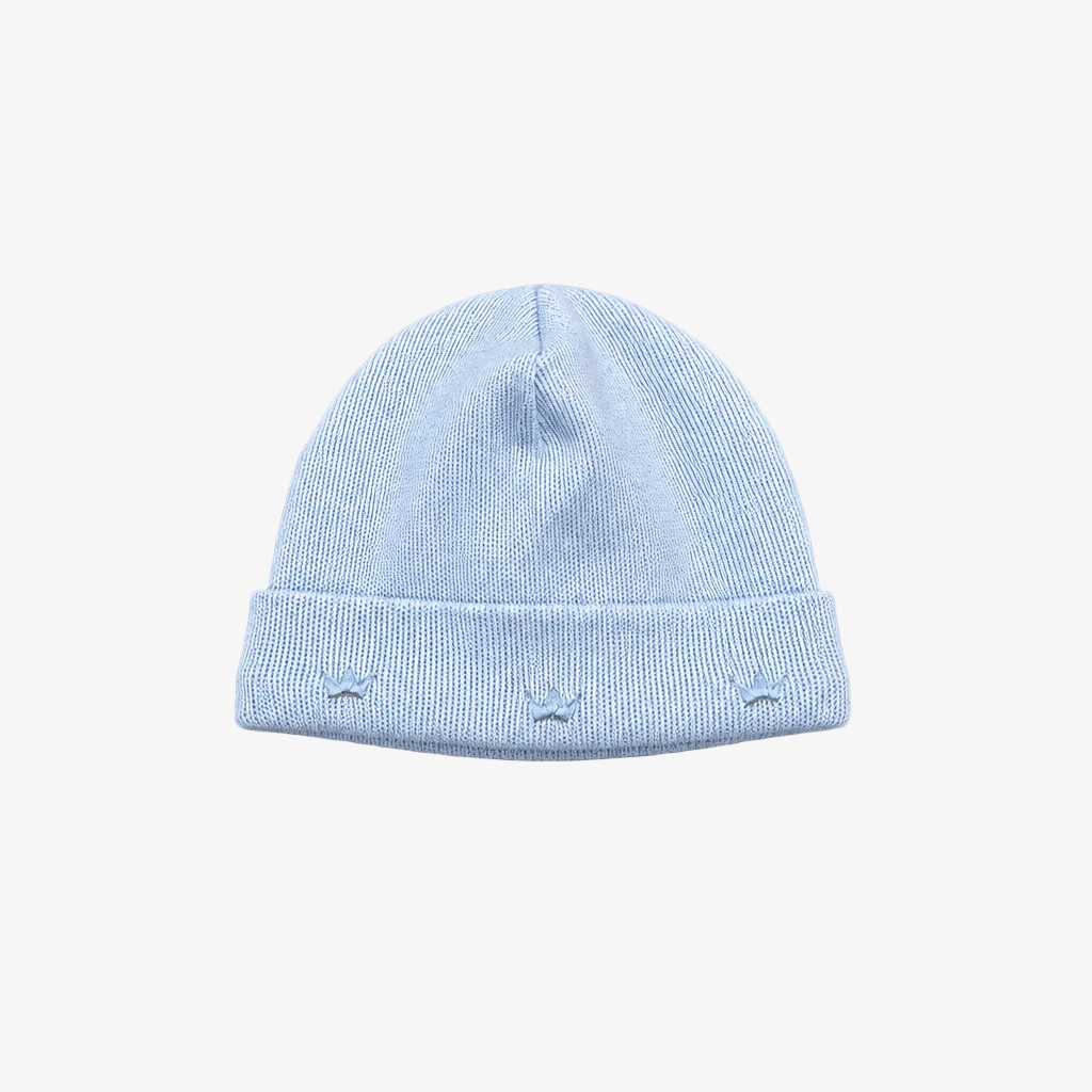 A light blue knit beanie hat with a folded cuff, featuring three small embroidered star details on the front, shown against a neutral gray background.