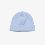 A light blue ribbed knit beanie hat with a folded cuff, centered on a neutral gray background.