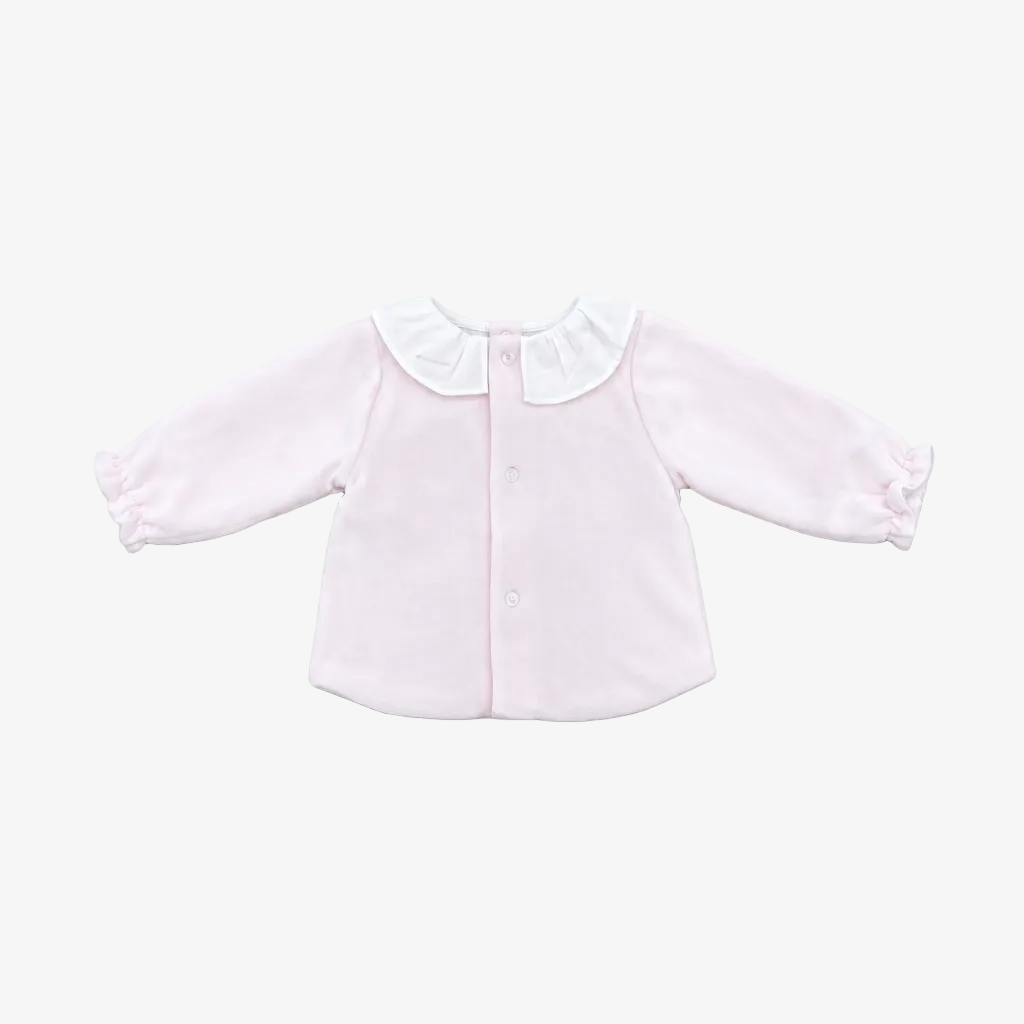 A light pink long-sleeve baby cardigan with a white ruffled Peter Pan collar and button front, laid flat on a neutral gray background.