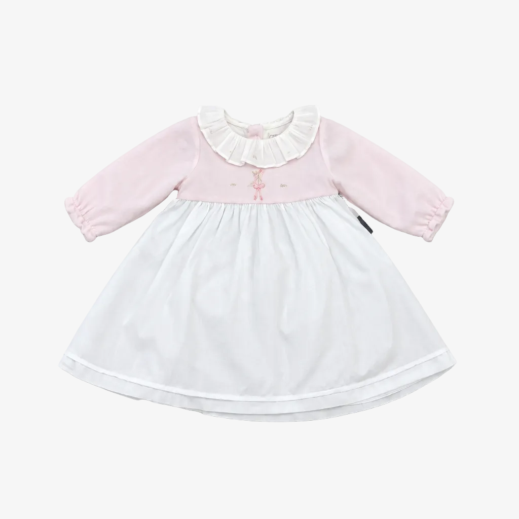A baby girl's long-sleeve dress with a light pink bodice, white ruffled collar, and a white skirt, laid flat on a neutral gray background.