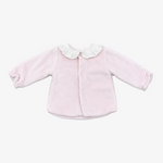 A light pink long-sleeve baby cardigan with a white ruffled collar, laid flat on a neutral gray background.