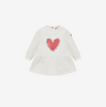 White baby dress with a red heart design on a white background